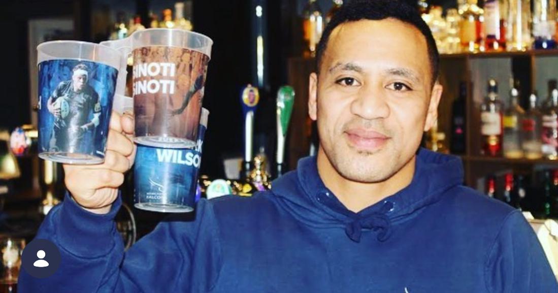 People holding printed reusable pint cups at an event bar
