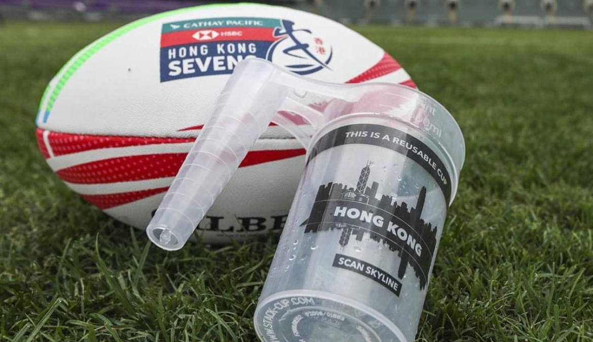 A rigid reusable stack cup on grass at an outdoor sports event