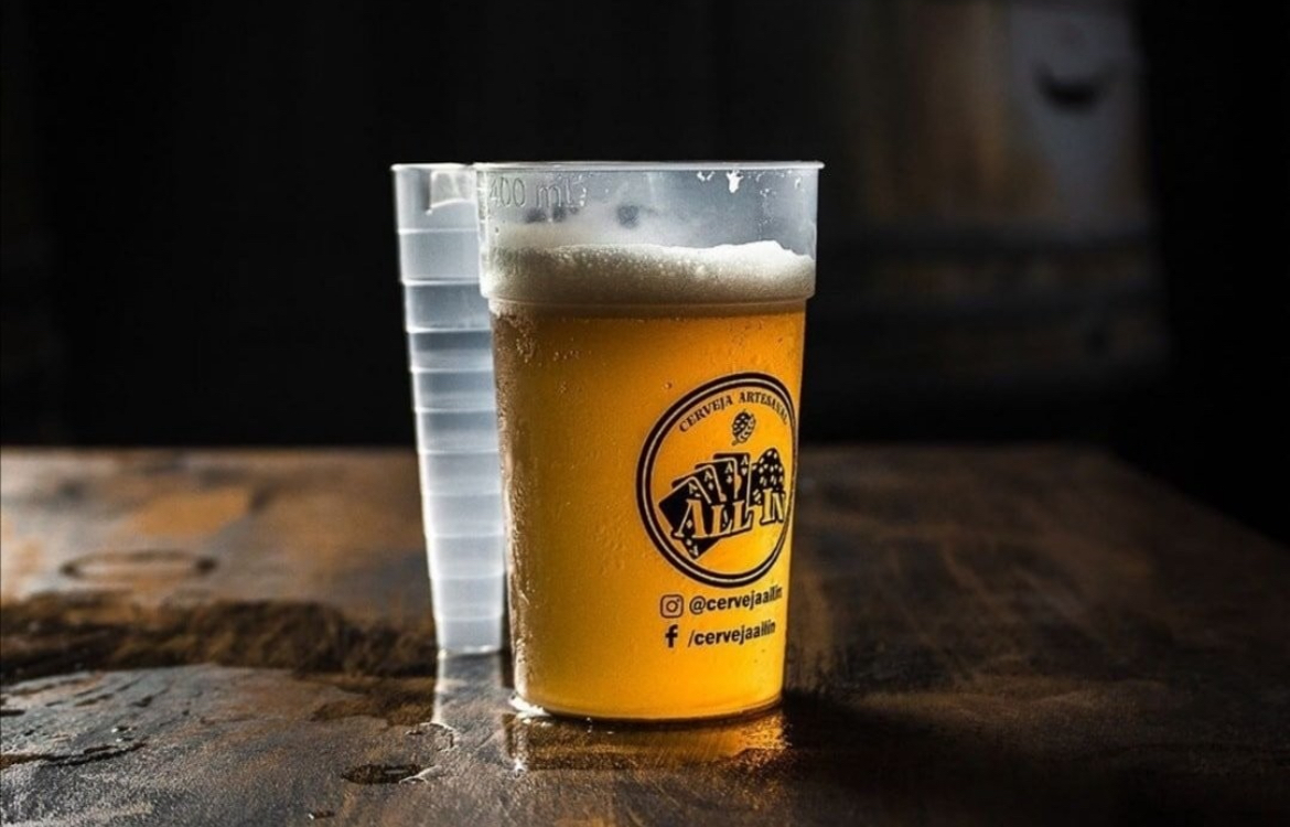Transparent BPA-free polypropylene reusable pint cup filled at a bar